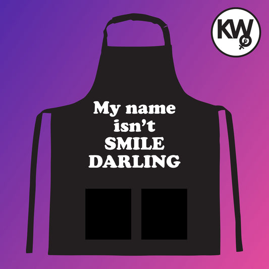 Apron with “MY NAME ISN’T SMILE DARLING” hand screenprint.